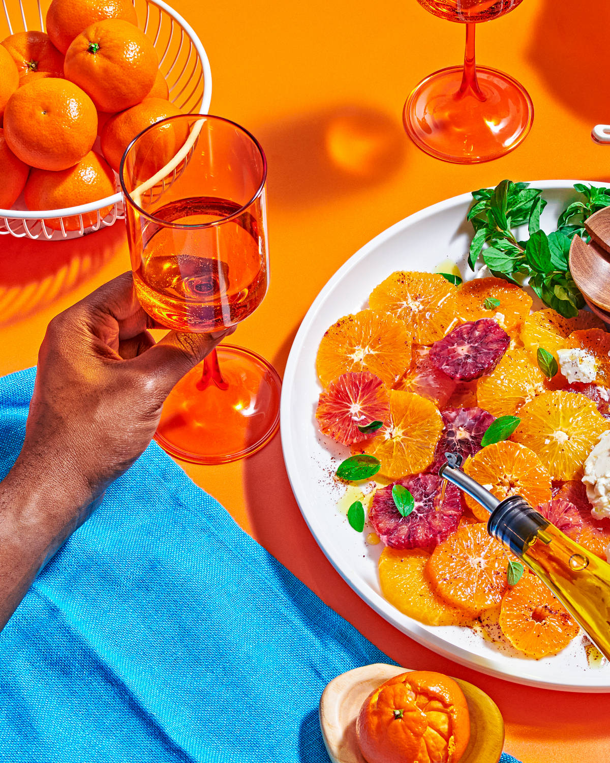 A table with a bowl of Peelz mandarin oranges and a platter of mandarin orange salad.